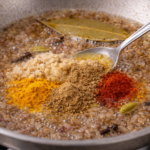 masala in the sauted onion for chicken masala